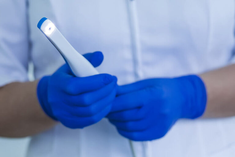 Dentist holding a intraoral camera, a technology used in-office at port Washington Family Dentistry.