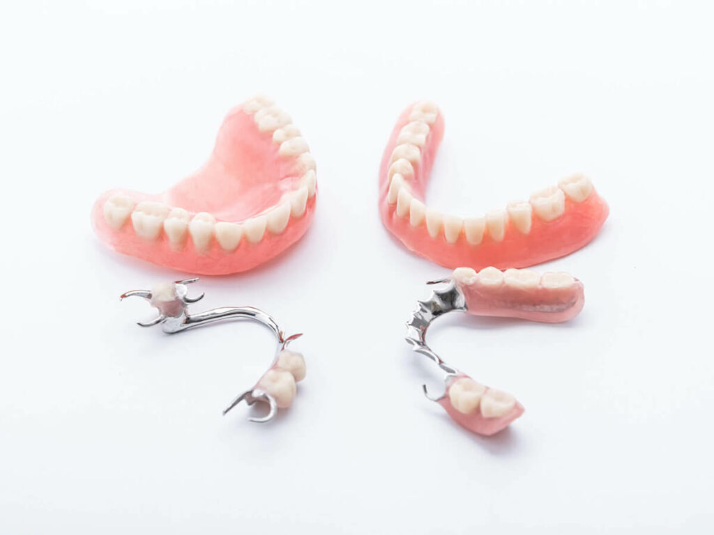 Photo of different kinds of dentures on a white background.