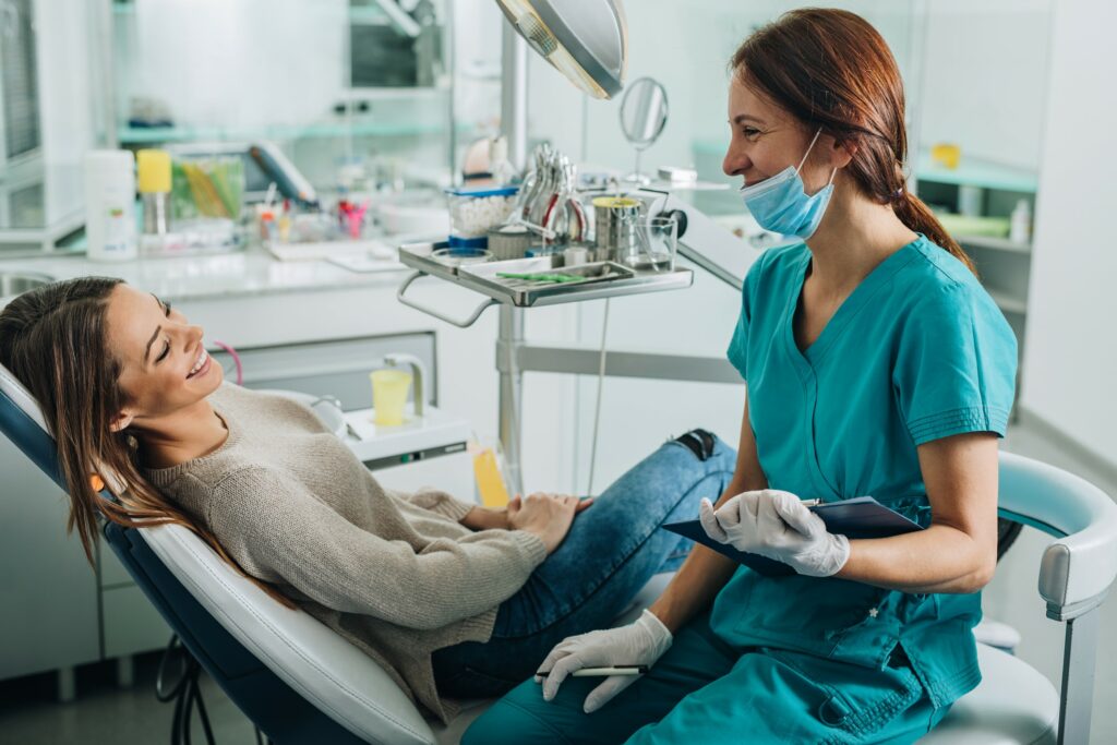 Dental professional having a chair-side discussion with a patient.