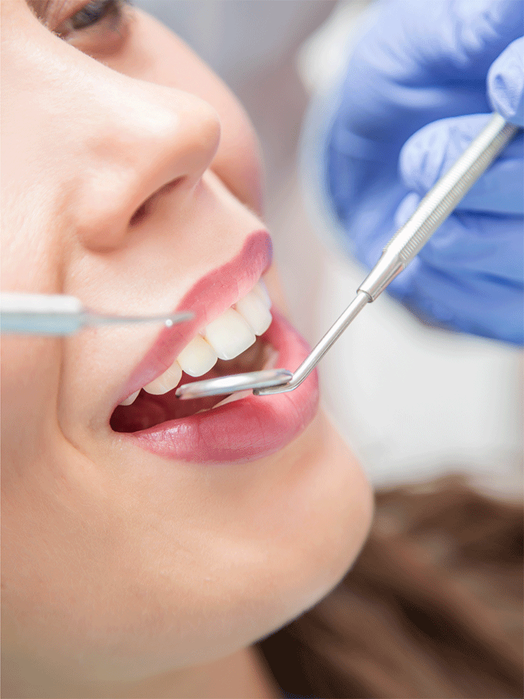 Closeup of a dentist performing a regular dental cleaning on a patient.
