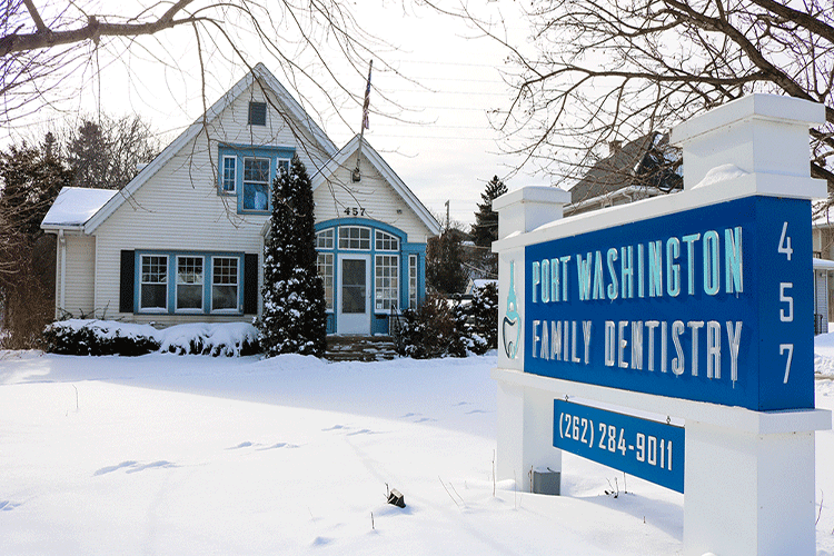 Exterior photo of Port Washington Family Dentistry in Port Washington, WI, covered in snow.